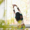 Woman stretching in kitchen