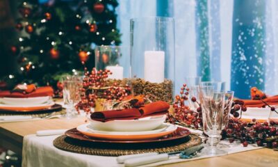 Festive place setting table, next to the Christmas tree