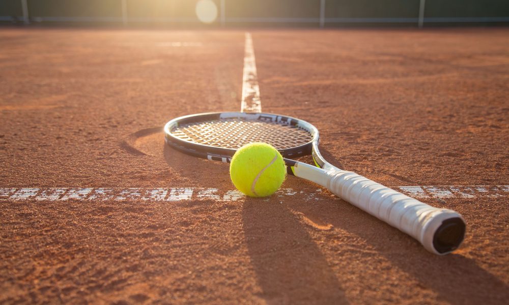 Close up,Tennis,Racket,And,Ball,Placed,On,Court,Ground.