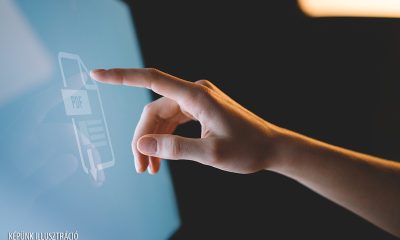 Human,Finger,Pointing,On,The,Glowing,Computer,Screen,With,Blue