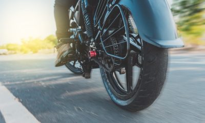 Low angle view of a motorcyclist riding motorcycle. close up of motorcyclist feet on his motorbike. low angle view of a biker driving his motorbike